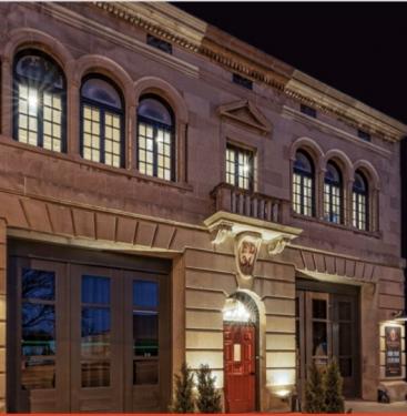 The exterior of the Fire House is lit up at night.