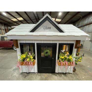 Playhouse with flower boxes in front windows