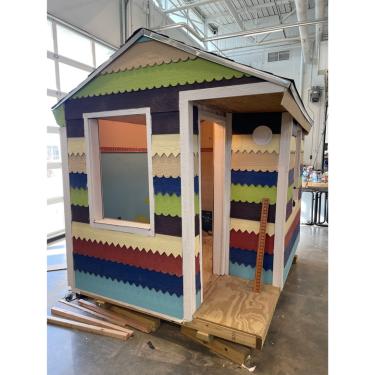 Bonner Springs gingerbread style playhouse with colorful siding.