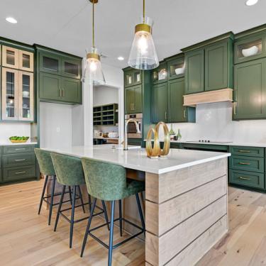 Photo of kitchen with green cabinets.